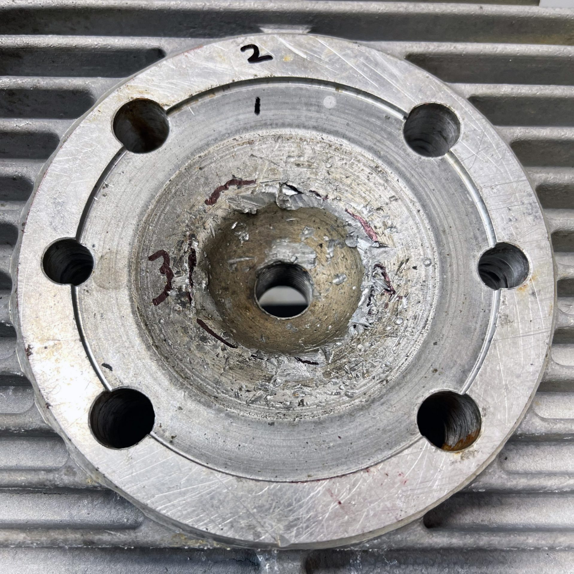 Step1 First, inspect the damage to see if the head is even repairable without welding. We decided to first machine the cylinder sealing surface (#1) .020”, the head-to-muff surface (#2) .020” second and the squish band (#3) .020” third. If the squish band did not clean up at .020” we would have started over on all three surfaces with an additional .010” cut. The object is to remove the least possible amount of material and still restore the surfaces.