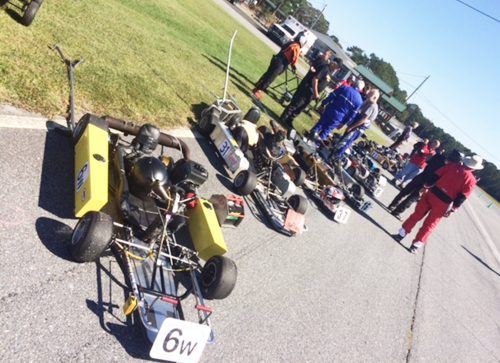 Arthur McKenny’s kart (#6w) at the head of the starting grid