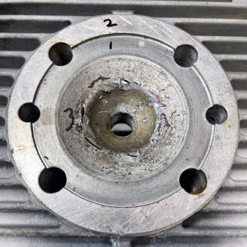 First, inspect the damage to see if the head is even repairable without welding. We decided to first machine the cylinder sealing surface (#1) .020”, the head-to-muff surface (#2) .020” second and the squish band (#3) .020” third. If the squish band did not clean up at .020” we would have started over on all three surfaces with an additional .010” cut. The object is to remove the least possible amount of material and still restore the surfaces.