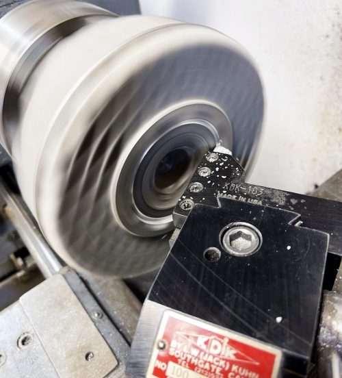 We first machined the head-to-barrel sealing surface. To do this we ran the lathe in reverse (clockwise) so that we could easily see the cutting tool. Important because the tool must cut all the way into the corner of the “step” for the liner. The cylinder must be very tight on the mandrel or it will unscrew from the force of the cutting tool.